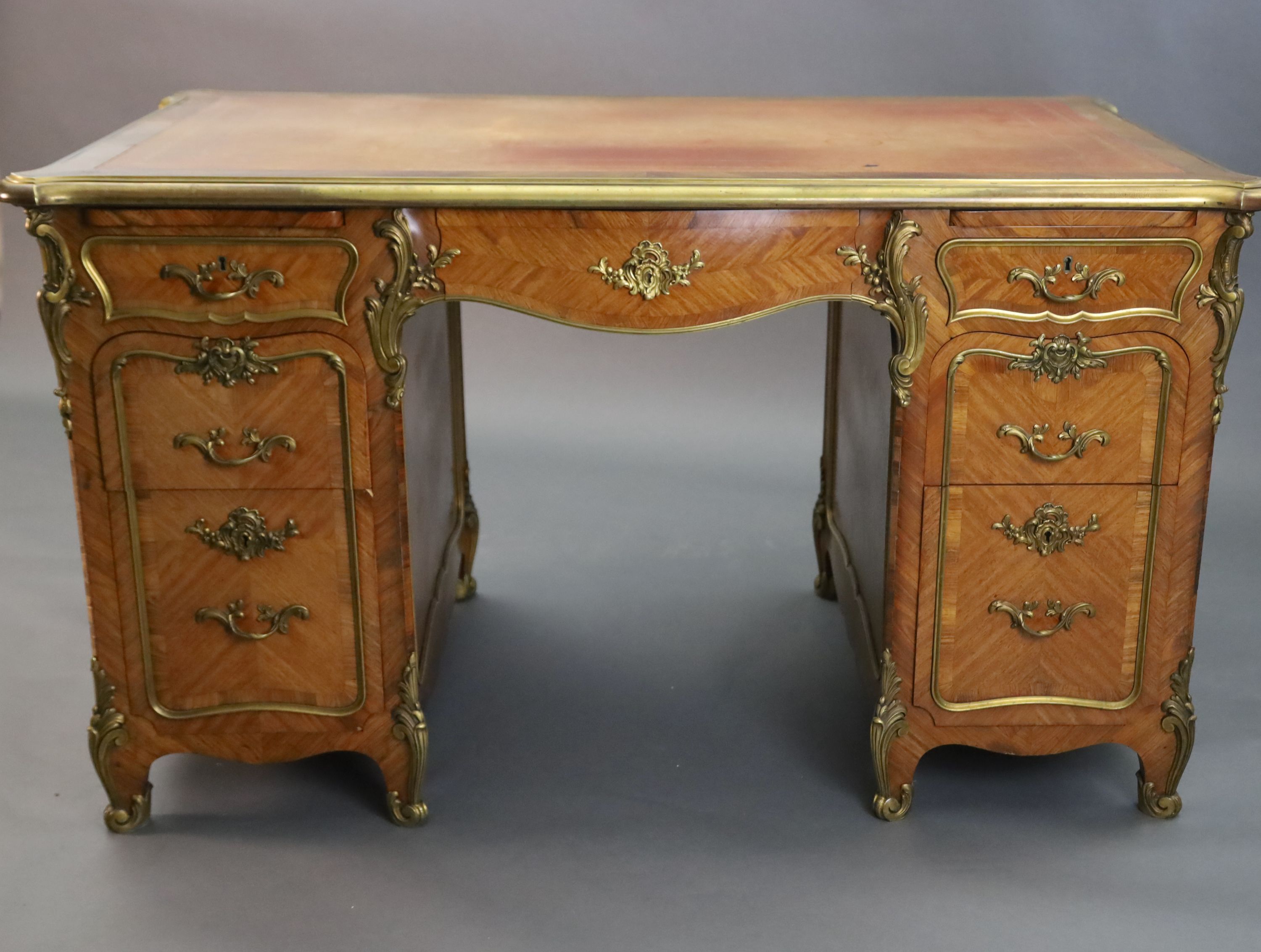 An early 20th century Louis XVI style ormolu mounted satinwood and rosewood kneehole desk, W.4ft 5in. D.2ft 8in. H.2ft 6in.